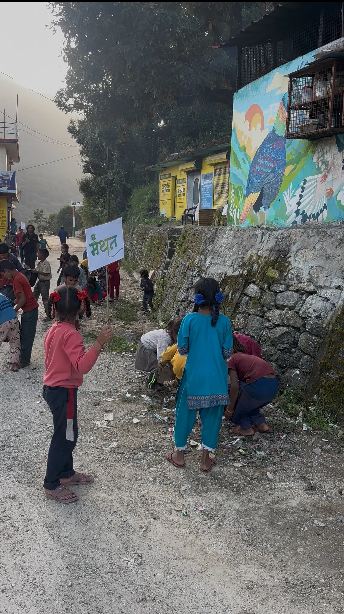 Young children taking part in the community cleanliness activity